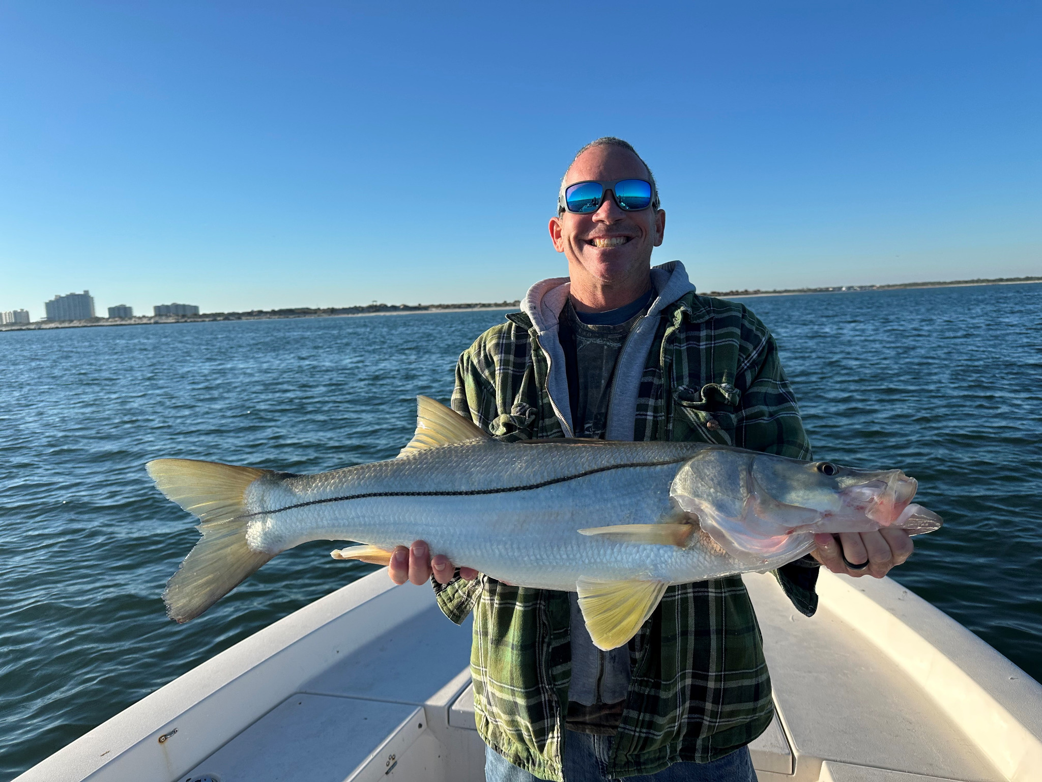 New Smyrna Beach Florida fishing page featuring a large snook on a boat